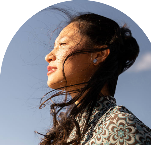 Person looking towards the sun, representing hope and mental wellness